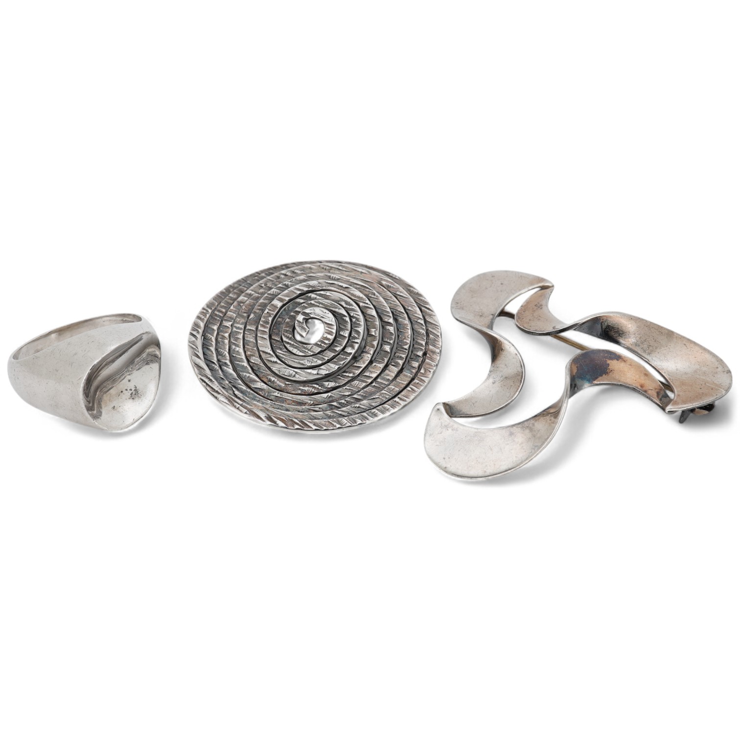A mid to late 20th century Danish sterling tri-form brooch and a 925S ring by by Carl Ove Frydensberg, brooch, 43mm and a 1970's Finnish 925 circular brooch, by Kuppittaan Kulta, Turku, diameter 36mm.